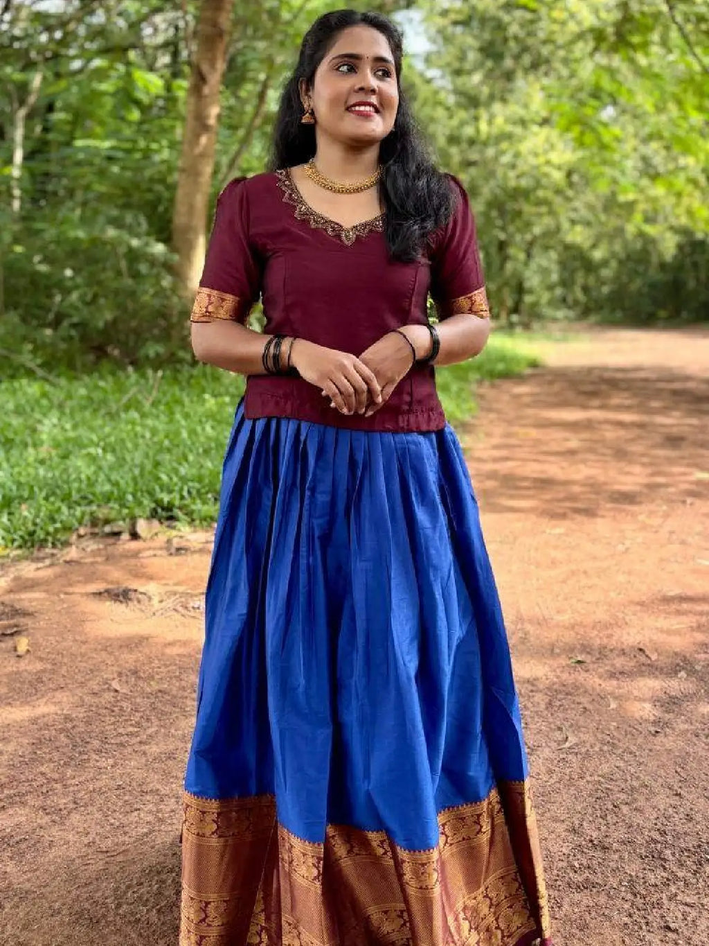 Vichitra silk top with beautiful handwork on neck and narayana patt skirt.